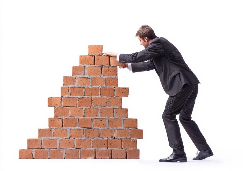 businessman pushing a brick wall, determined effort, futility