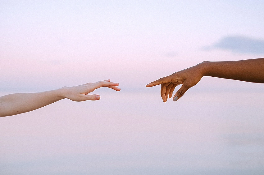 Two hands reaching out to connect
Cover image search term: Pexels photo of two people holding hands in a gentle, warm light, not facing the camera