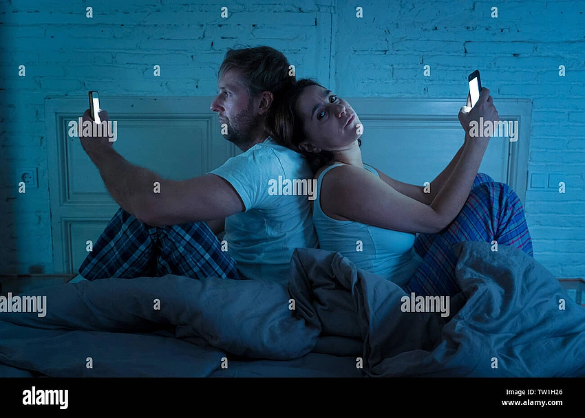 Couple staring at phone screen, uneasy atmosphere