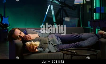 Exhausted person on couch after movie, overwhelmed by film, emotional hangover from movie