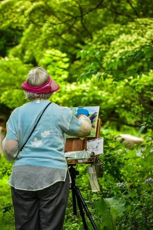 woman painting freely, happy solo date, adult playing outdoors