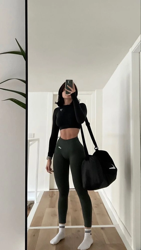 woman in minimalist gym wear exercising, modern gym aesthetic
