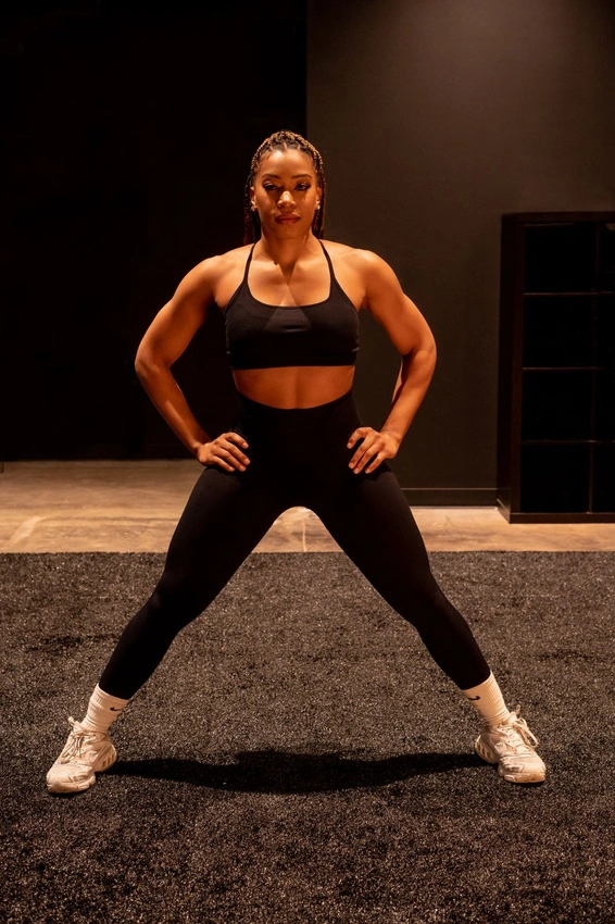woman confident gym pose, strong female athlete