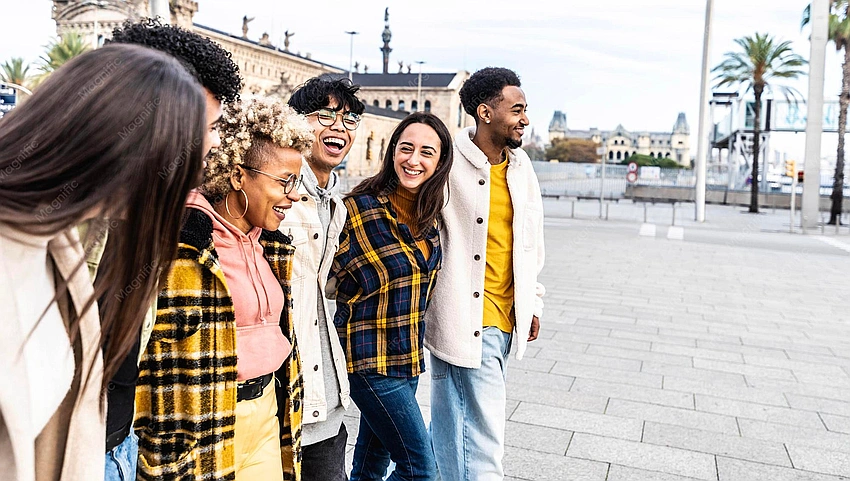 diverse group of friends smiling and walking together in city