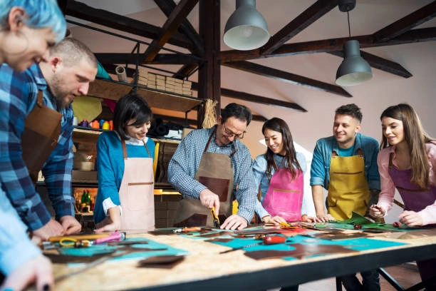 People learning a craft together, smiling and chatting
