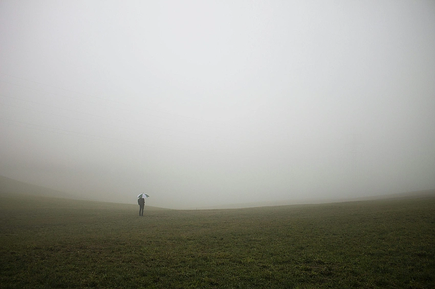 foggy field, lonely figure in distance