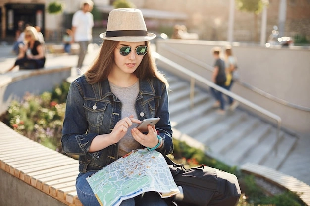Teenagers looking at a map on a phone, travel context