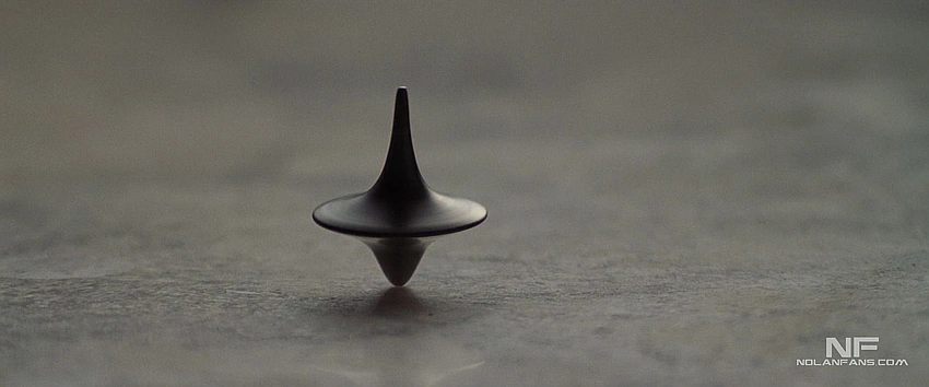 spinning top dark background movie still