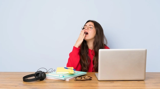 Teenager yawning studying, student afternoon slump