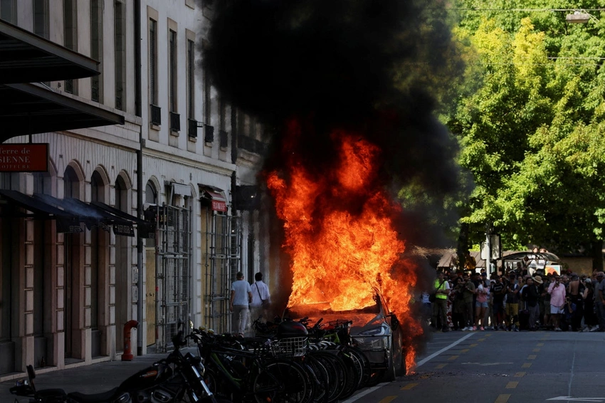 Chaos in Geneva: G7 Protesters Clash, Tesla Torched, UN Windows Smashed!