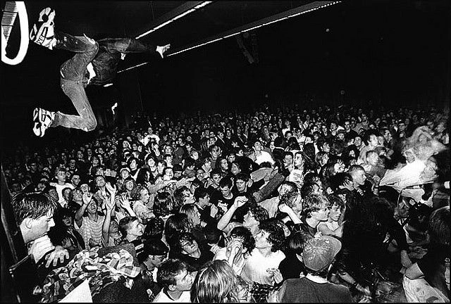 Kurt Cobain performing intense, grunge concert crowd