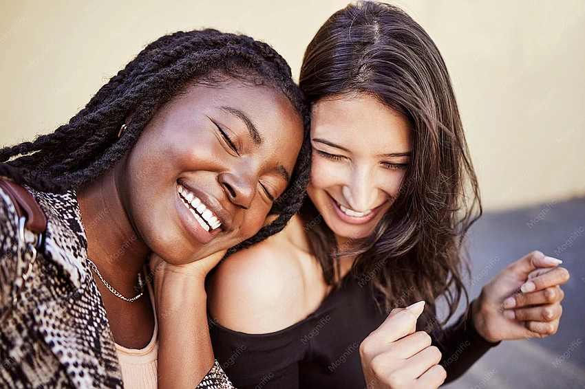 happy young woman laughing with supportive friends, no phones