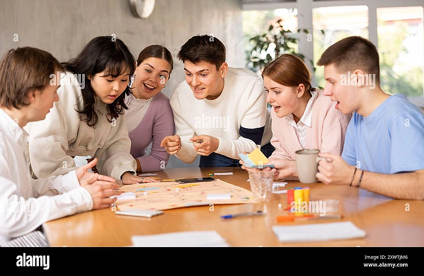 College students playing board games laughing