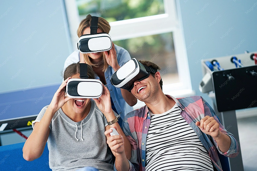 College students playing video games laughing