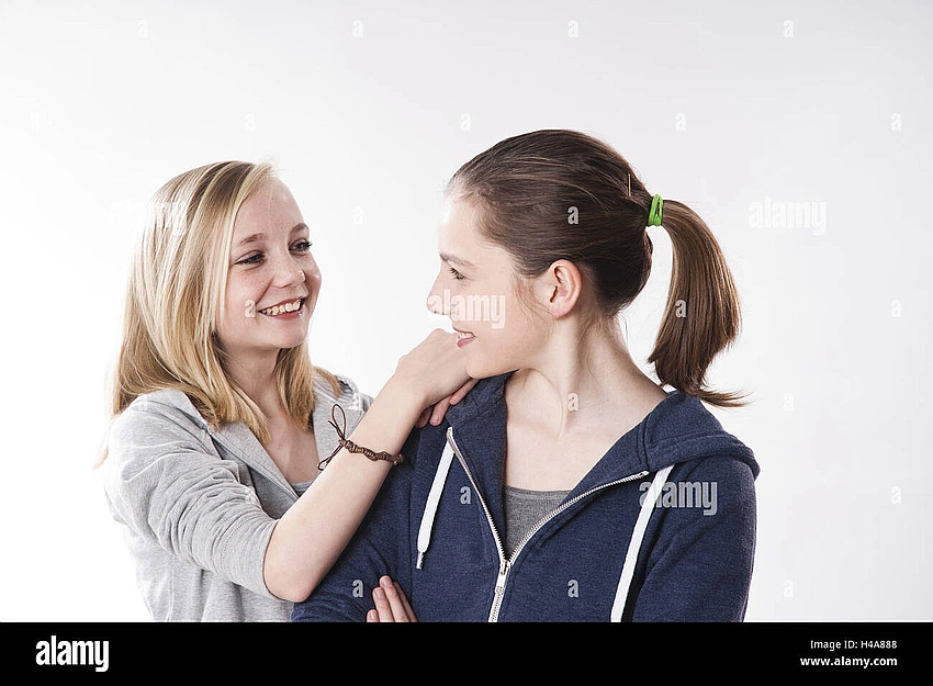 Two teenagers making eye contact and smiling shyly