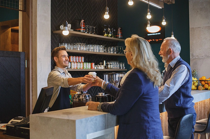 man being polite to barista, kind interaction with service staff