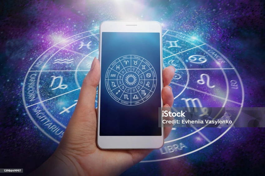 Woman looking at phone with cosmic background, neon astrology app