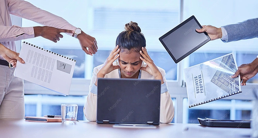 'Young woman looking stressed, caught between two groups'