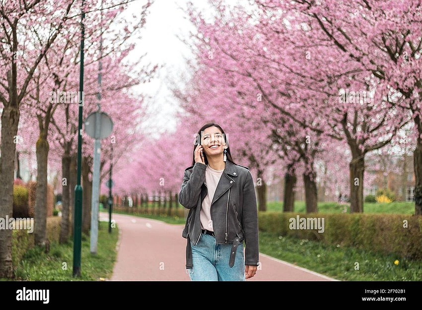 Confident young woman walking alone in a vibrant park