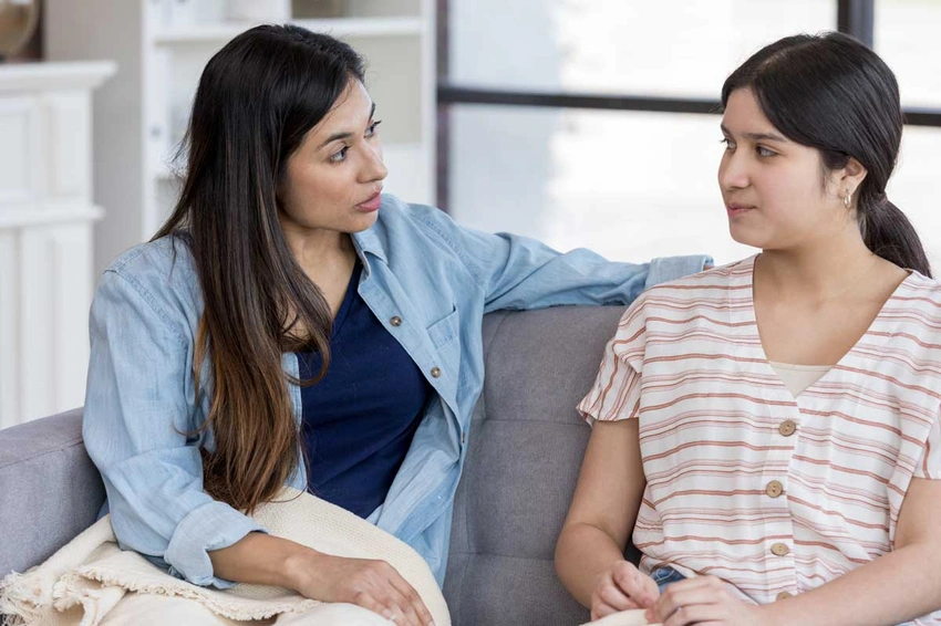 woman talking to mother, reassuring parents, family conversation