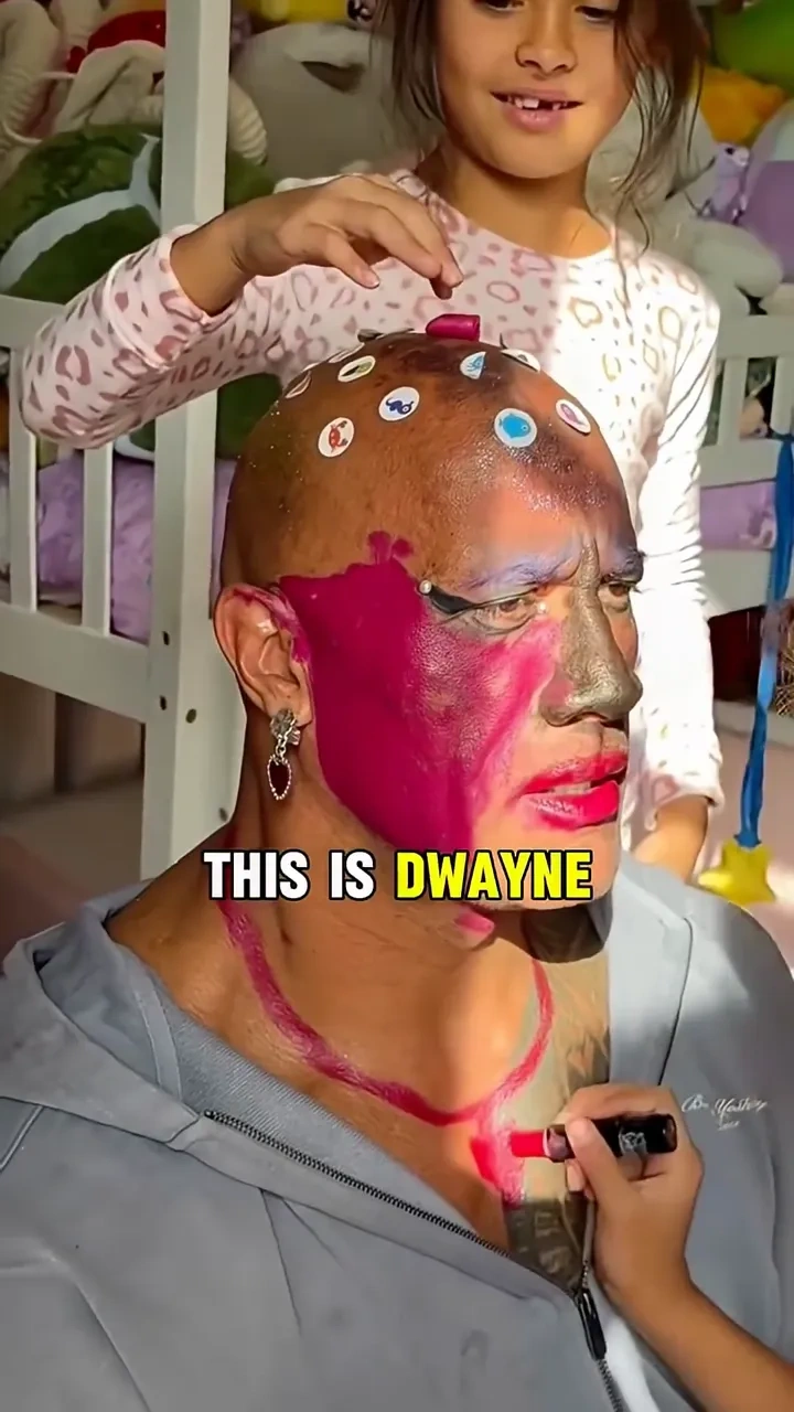 Rock's pink makeover: 

The Rock lets his daughters give him a pink makeover, lipstick, doodles and 